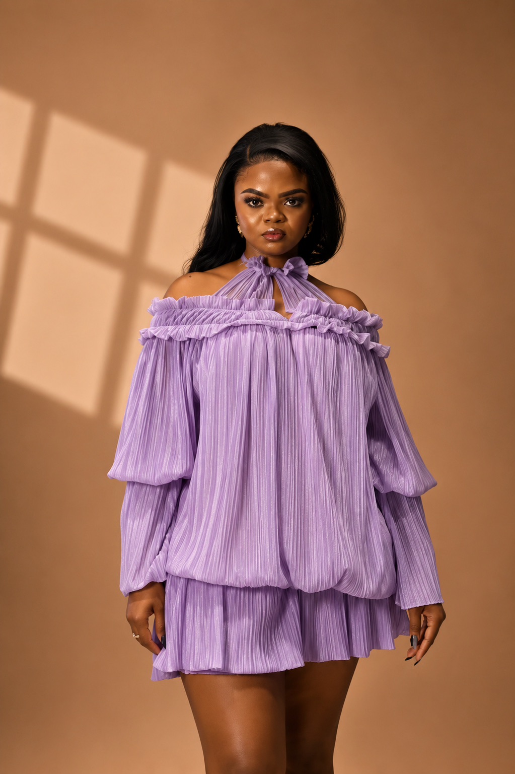 Woman wearing a lavender pleated JINNA outfit