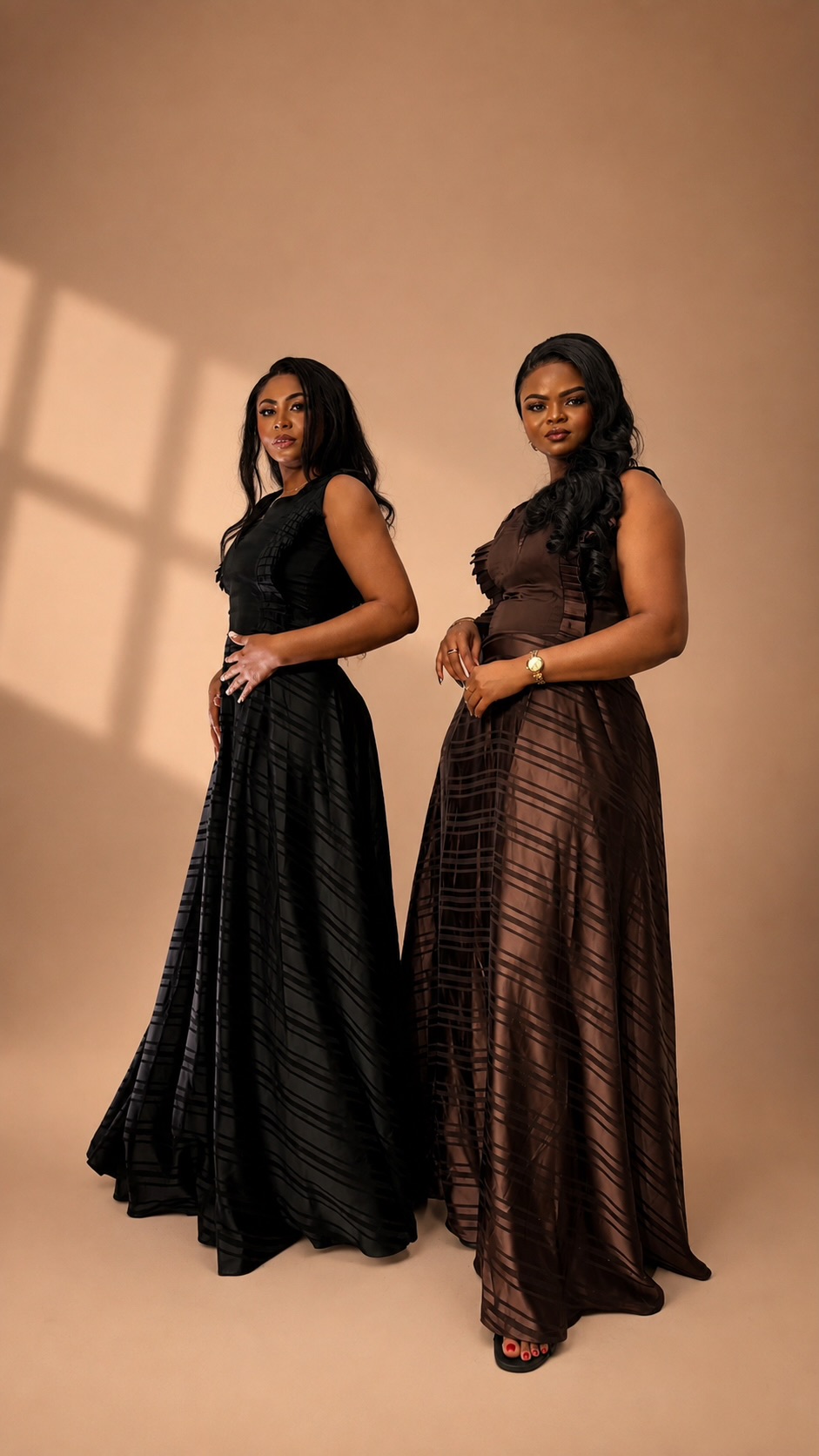 Two women wearing black and brown JINNA gowns