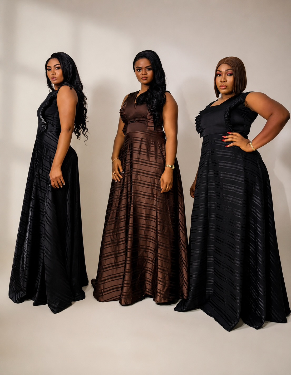 Three women wearing black and brown JINNA gowns